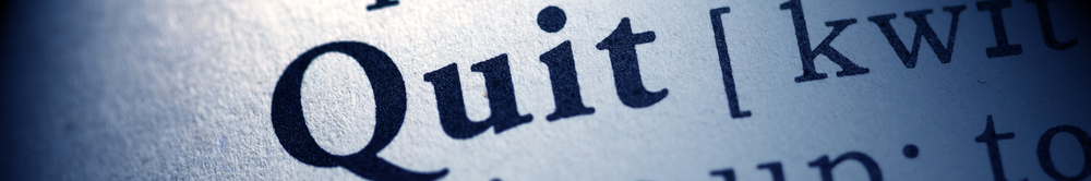 Close-up of the word ‘Quit’ printed in bold text, used as the feature image for an article about terrible ways to quit your job.