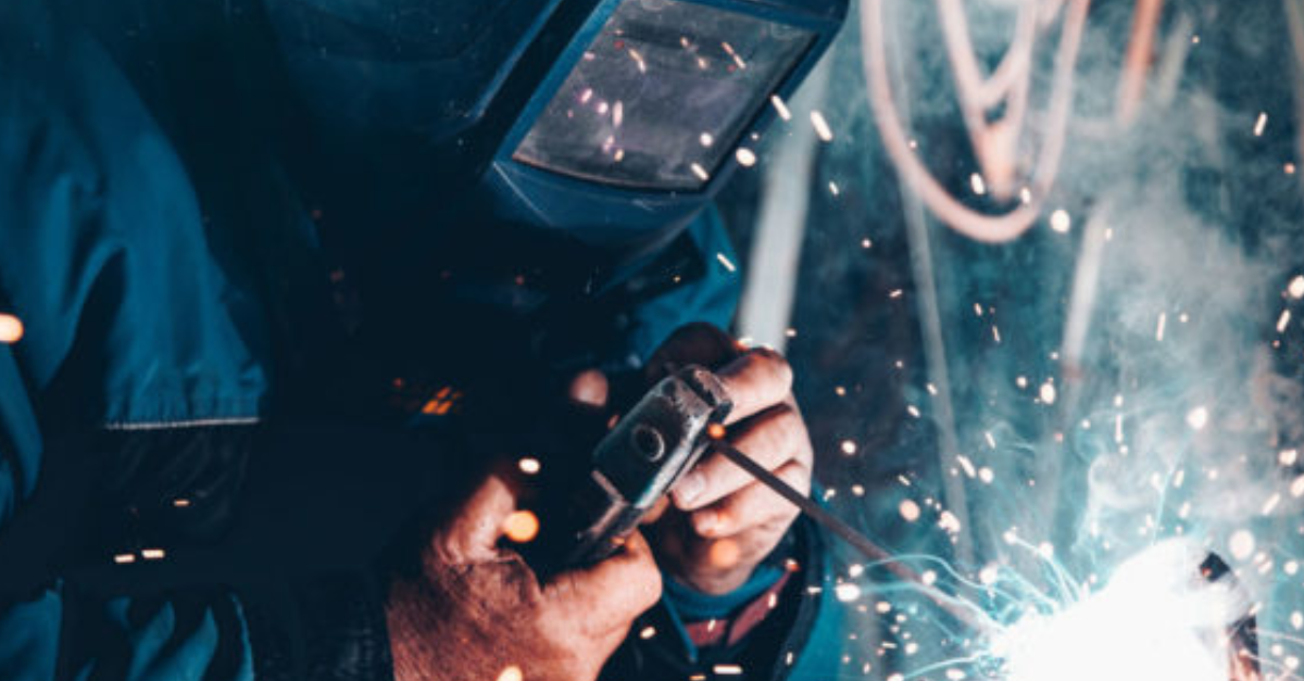 A plater working in protective gear