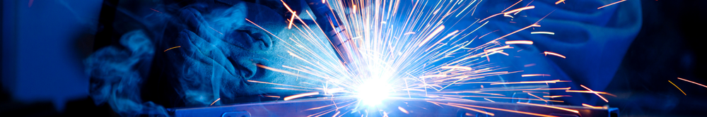 Close-up of a welder's spark shower during metal fabrication work