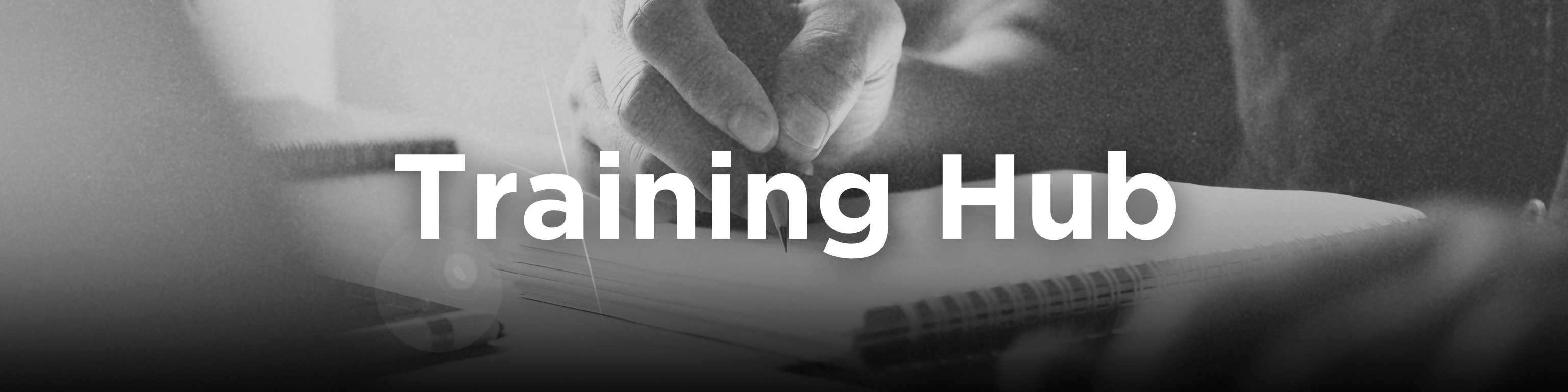A black and white image of a mans hand writing an article